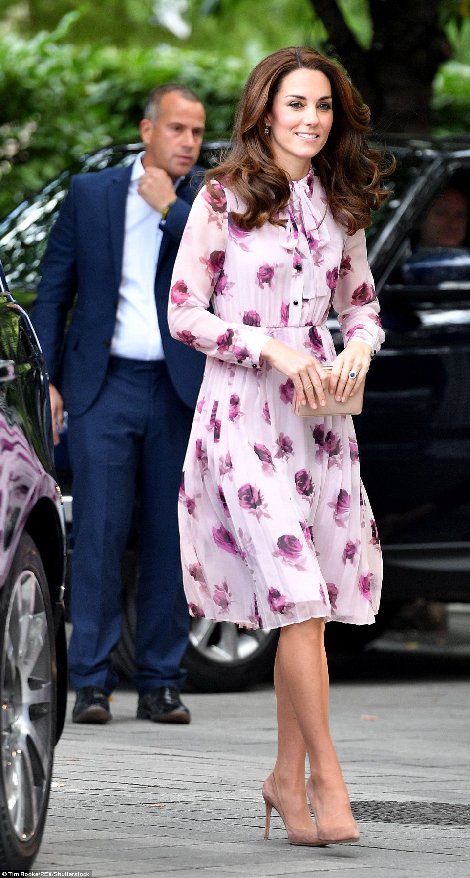 Kate Middleton stepped out this week for World Mental Health Day in a beautiful, soft pink Kate Spade dress.  She paired the floral, midi dress with nude pumps and a box clutch.