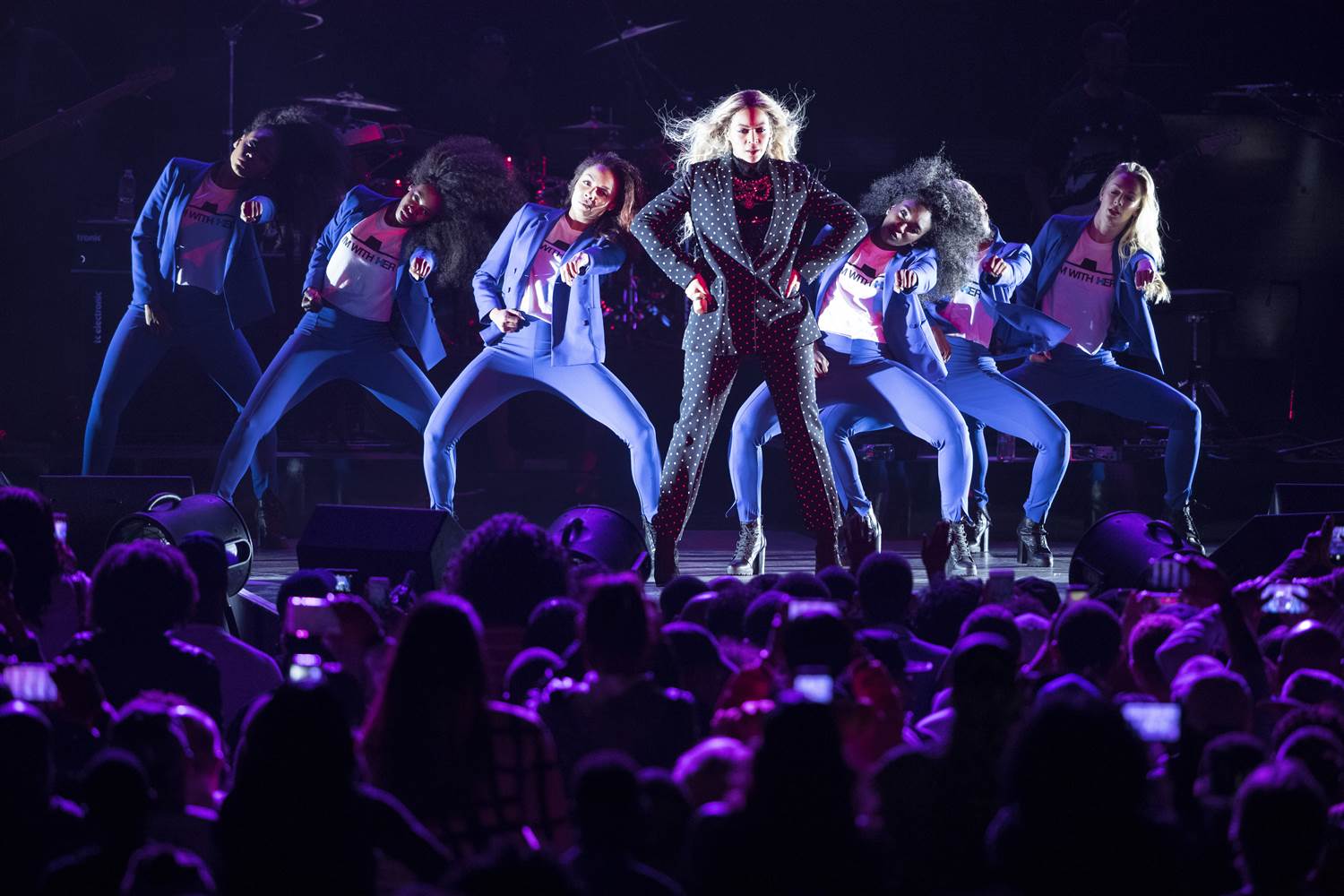 Beyoncé performed at a Get Out the Vote concert for Hilary Clinton, referencing Clinton's iconic look by costuming her backup dancers in blue pantsuits.  