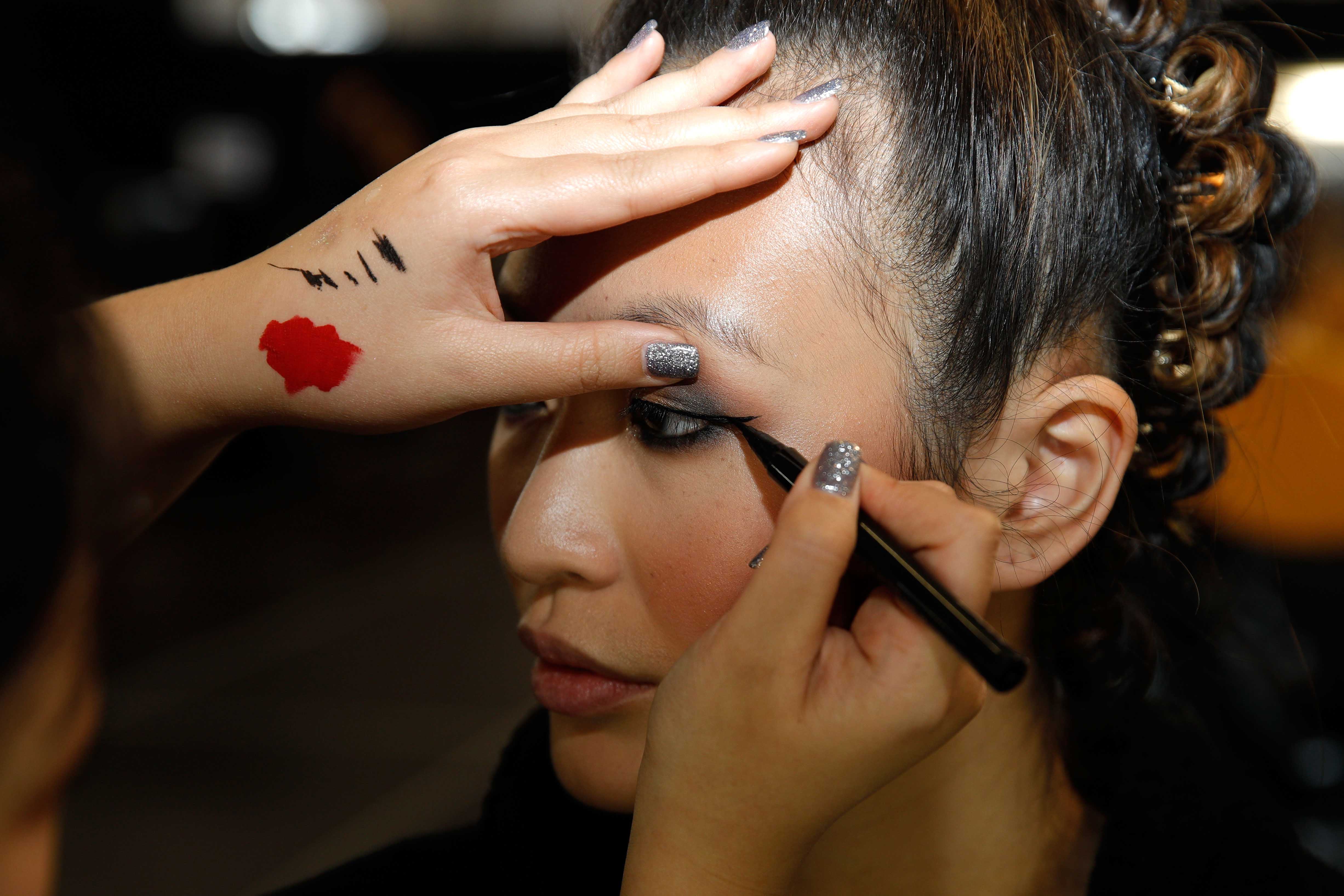 AUCKLAND, NEW ZEALAND - AUGUST 29:  A model prepares backstage ahead of the Kathryn Wilson show during New Zealand Fashion Week 2018 at Viaduct Events Centre on August 29, 2018 in Auckland, New Zealand.  (Photo by Michael Ng/Getty Images)
