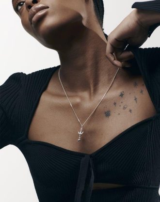 Woman shows off silver necklace and collarbones
