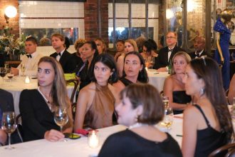 Crowd of young women are seated at a long table