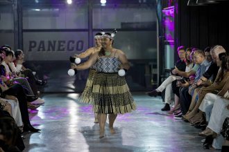 Maori woman with poi on runway for fashion show
