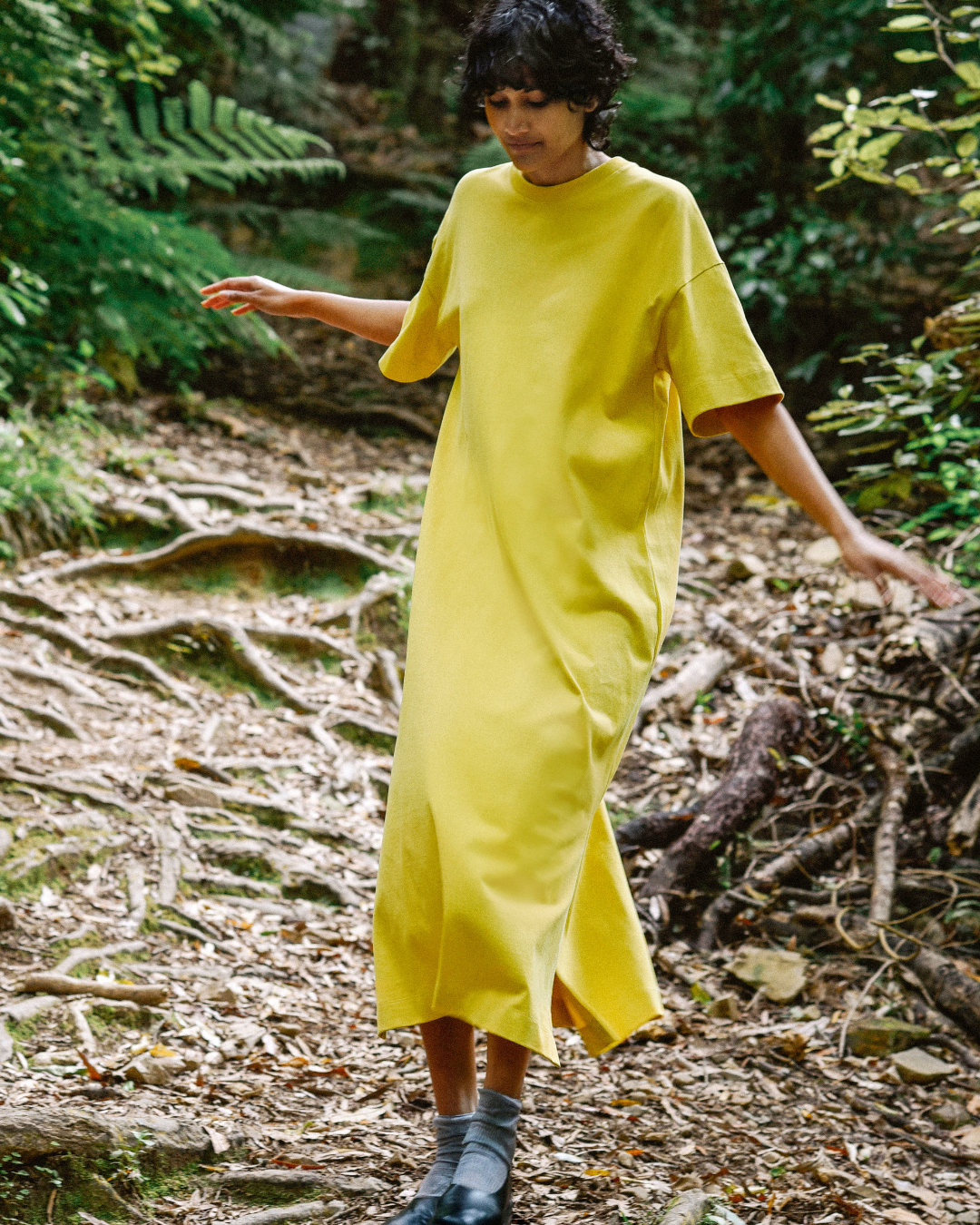 Woman wearing a yellow dress in forrest