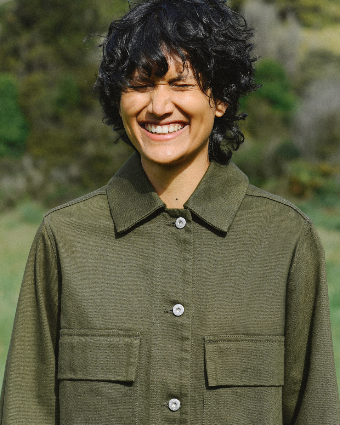 Woman smiling wearing green jacket