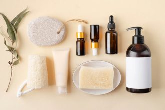 A group of beauty products layed out on a beige background