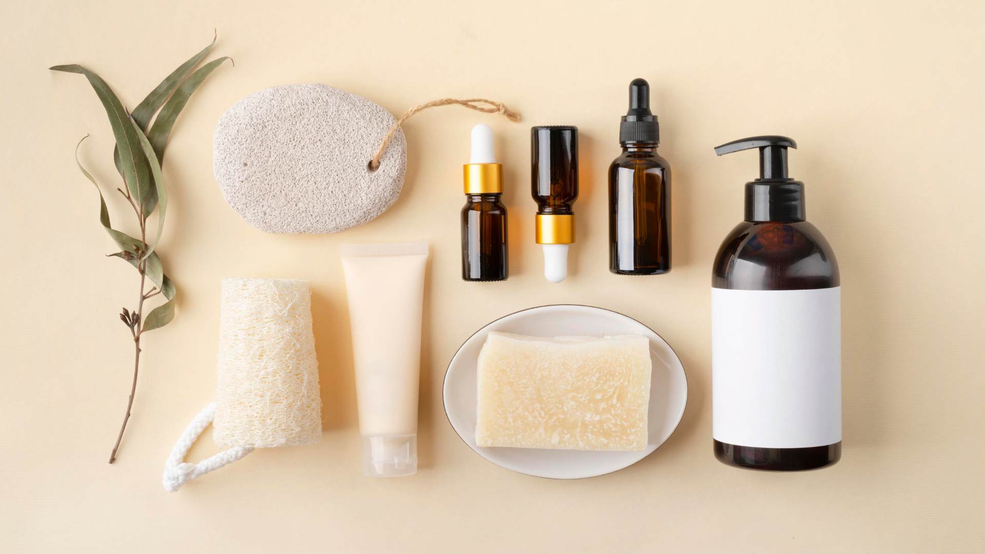 A group of beauty products layed out on a beige background