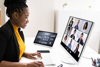 A woman hosting an online webinar at a desk